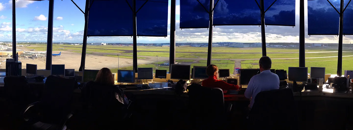 Controllers in a tower overlooking the runway, part of the ground operations shadowed during research