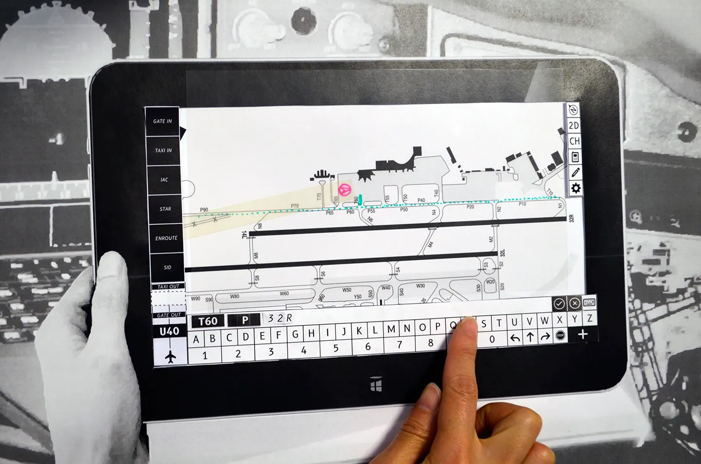 Hands entering a taxi clearance on the prototype, the map showing the highlighted cleared route and keypad