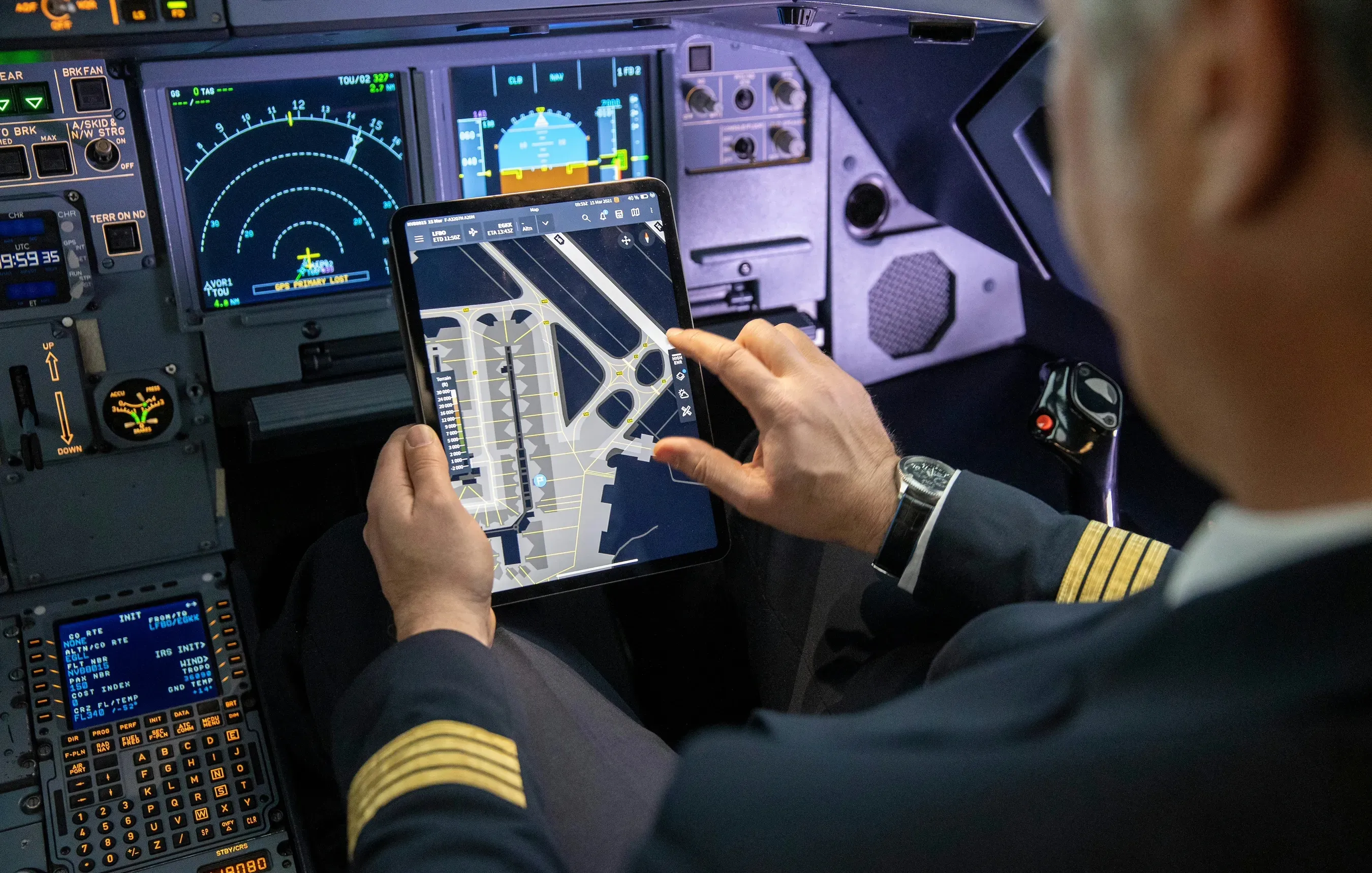A pilot in the cockpit using a tablet airport moving map while taxiing, the tool this project shaped
