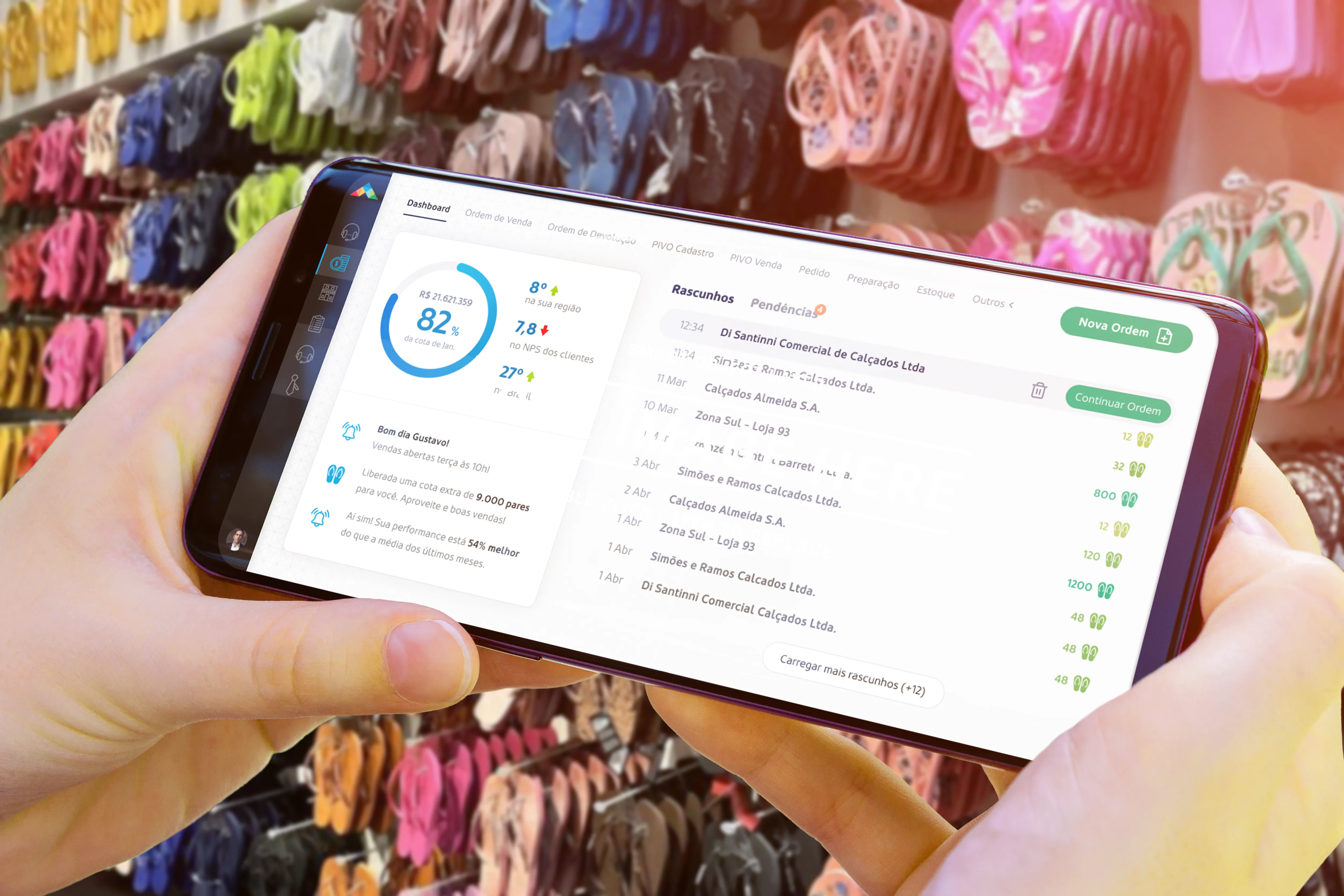 The redesigned platform on a phone held in-store, putting a live sales dashboard and stock in the rep's hand